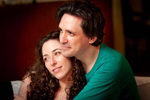 Candid and romantic lifestyle portrait of a couple embracing, photographed by Eliot Khuner in Maui